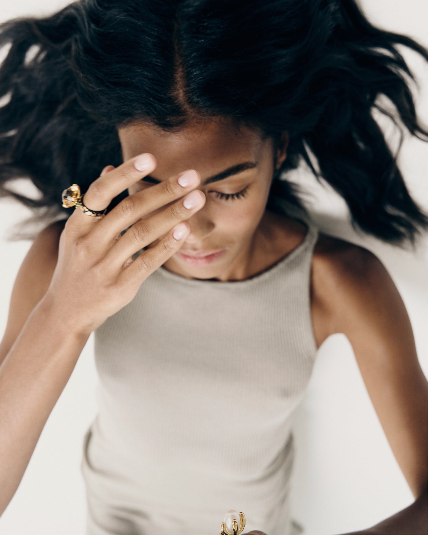 Model wearing handcrafted Rara gemstone ring in gold setting
